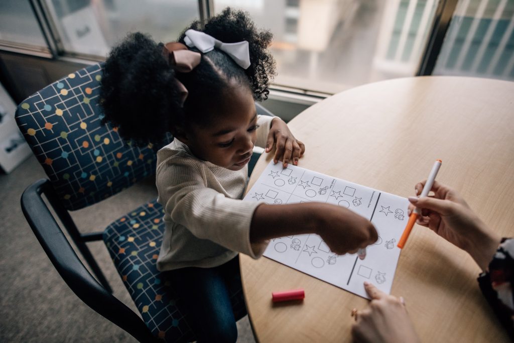 young girl taking an assessment